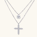 Two delicate sterling silver necklaces with moissanite stones - one solitaire pendant and one cross pendant on white background.