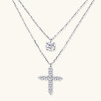 Two delicate sterling silver necklaces with moissanite stones - one solitaire pendant and one cross pendant on white background.