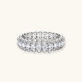Sterling silver eternity ring with continuous row of brilliant moissanite stones in scalloped crown setting with milgrain detail
